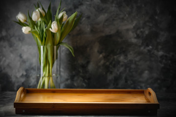 Fotomurales - Dark mood background and fresh flowers of tulips.