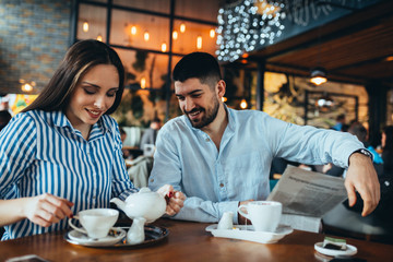 Wall Mural - happy couple drinking tea in cafe