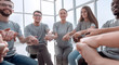 © ASDF - close up. United team of young people sitting in a circle