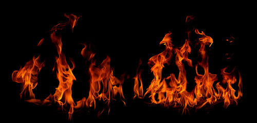 Wall Mural - On fire flames at the black background