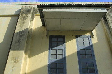 An ancient architecture building in the art deco style with the characteristics of a large window frame.