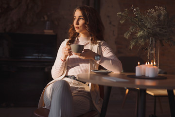 Portrait of young woman drinking coffee in a cafe