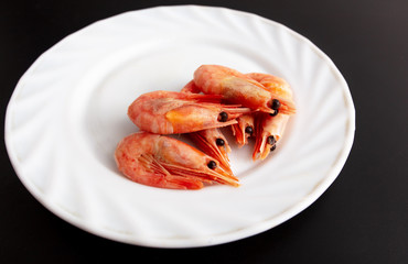 Poster - Red shrimp in a white plate on a black