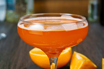 Two beautiful cocktails served on a wooden bar counter