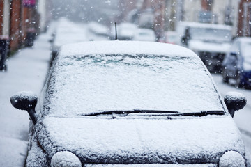 Vehicle small car covered in Snow during Winter Storm.