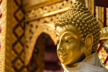 Buddha statue at Wat Phra That Doi Kham in Chiang Mai Thailand.