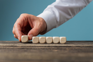 Wall Mural - placing six blank wooden dices in a row