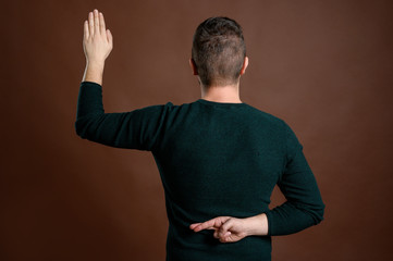 Man with brown hair showing fake oath