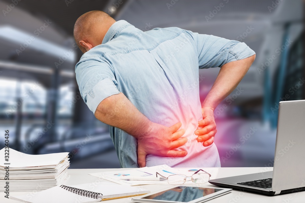 Business man with back pain in office Stock Photo | Adobe Stock