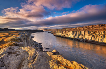 Wall Mural - Colorful clouds over Selfoss waterfall. Iceland, Jokulsa National Park, Fjollum river,  Europe. . Popular tourist attraction. Travelling concept background. Golden Ring Of Iceland. Beautiful Postcard.