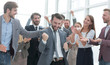© ASDF - close up. business team applauding their jubilant leader