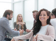© ASDF - successful business woman sitting in front of a table in a conference room.