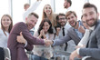 © ASDF - happy business people shaking hands in the conference room