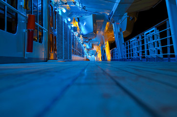 Blue Hour on empty promenade outside deck  of cruiseship or cruise ship liner with blue light at night