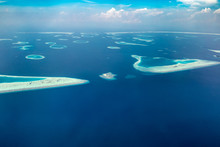Amazing Aerial Of The Beautiful Atolls Of The Maldives. Small Tropical Island In Maldives Atoll From Aerial View