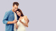 © vgstudio - Love, relationship, new parents and happy family concept - young couple, finding out results of a pregnancy test. Over grey background. Copy space for some text.