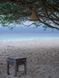 Beautiful beach view on Gili Meno Indonesia between the trees with a stool