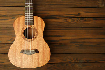 Ukulele  on wooden background