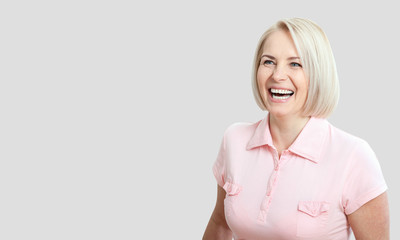 Wall Mural - friendly smiling middle-aged woman isolated on white background