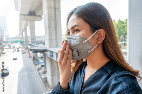 Beautiful woman wearing anti dust mask protect air pollution and pm 2.5 on street city