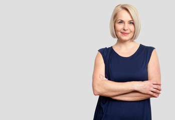 Wall Mural - friendly smiling middle-aged business woman isolated on white ba
