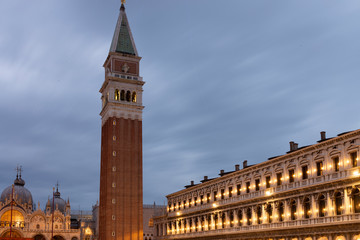 Night view of Piazza San Marco with a view of the basilica, the bell tower and the new Procuratie Venice, Italy. Suggestive lights at dayfall.