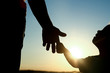 © Kostia - silhouette the parent holds the hand of a child