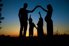 Silhouette Of A Happy Family With Children