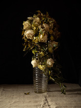 Wilted White Roses In A Vase In The Dimness Of The Room