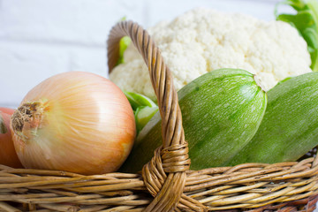 Wall Mural - Different vegetables in basket isolated on white