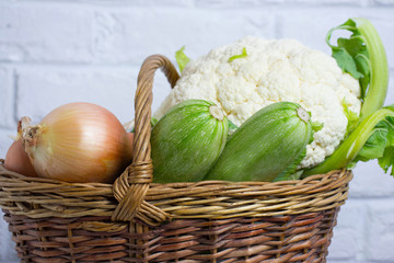 Wall Mural - Different vegetables in basket isolated on white