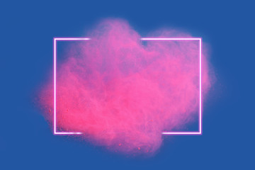 pink neon powder explosion with gliwing frame on blue background. colored cloud. colorful dust explo