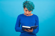 © carballo - young afro american girl with book isolated on blue background