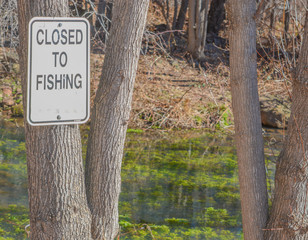 Wall Mural - Sign - Closed to Fishing. Arizona game and fish department at Tonto Creek Hatchery. Payson, Gila County, Arizona USA