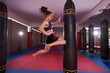 © Xalanx - Kickboxer female working with heavy bag