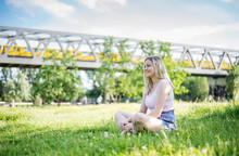 Smiling Young Woman Relaxing On A Meadow In Summer, Berlin, Germany