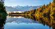 © Westend61 - New Zealand, Westland District, Fox Glacier, Lake Matheson reflecting surrounding forest and distant mountain range