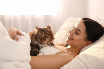 Canvas Print - Beautiful young woman with her cute cat on bed. Fluffy pet