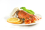 Fototapeta Londyn - Grilled lobster tail served on a white plate isolated on white, shallow focus