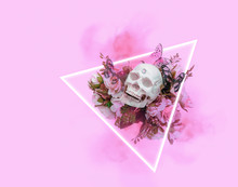 Skull With Flowers And Butterflies In Neon Triangle On Purple Background. Surreal Creative Concept. Atmosphere Magic Image. 