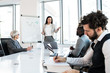 © Sanja - A young competent analyst presenting a graph to the company's team at the conference room.