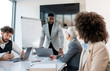 © Sanja - A young competent CEO holding a company meeting with three more businesspeople at the conference room.