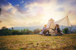 © Panumas - Young couples have good time morning on camping trip with sunrise background. Couples enjoy camping with morning coffee.