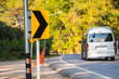 © bubbers - Chiang Mai , Thailand - January, 17, 2020 : Curve in the forest, Bend street up to the mountain, Traffic warning sign label for show that the road curves.