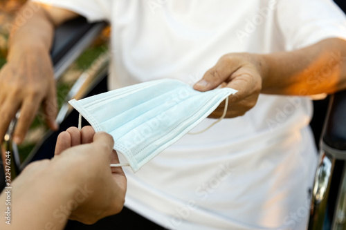 Cuadros en Lienzo Sharing makes us happy,female stranger is sharing medical face mask to the homel