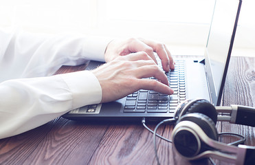 closeup of businessman typing on laptop computer