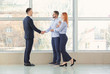 © Pixel-Shot - Bank manager and clients shaking hands in office