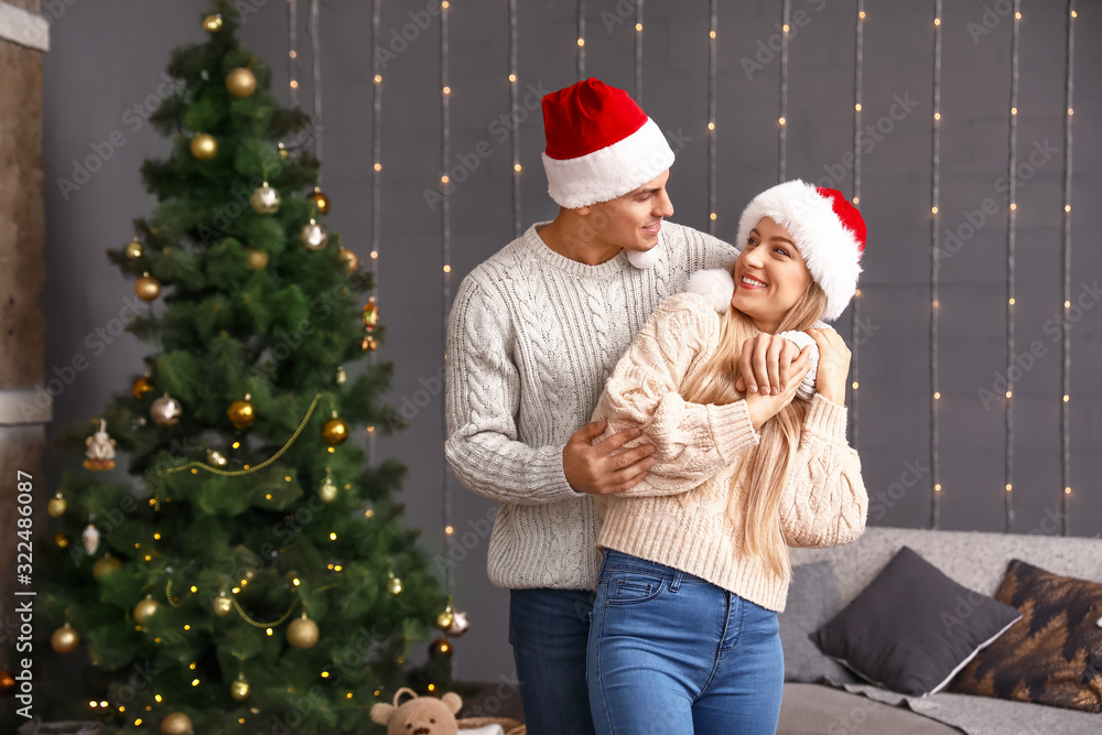 Happy couple on Christmas eve at home