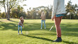 © Svitlana - Developing through fun and creativity. Parents play with daughter in badminton in the park on a sunny day