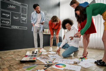 Wall Mural - team job. group of professional team of interior designers discussing sketches, choosing colors from
